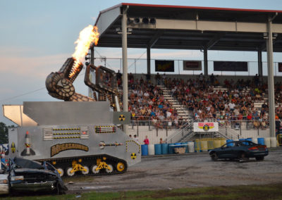 2012 Carlisle Truck Nationals with people in stands and megasaurus with fire coming out of its mouth
